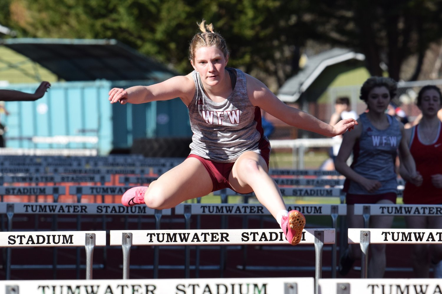 W.F. West's Emily Mallonee leaps over a hurdle at Tumwater District Stadium March 29.